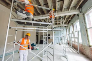 Workers assembling indoor scaffolding system for renovation project in Downey CA by Downey Scaffolding Rental