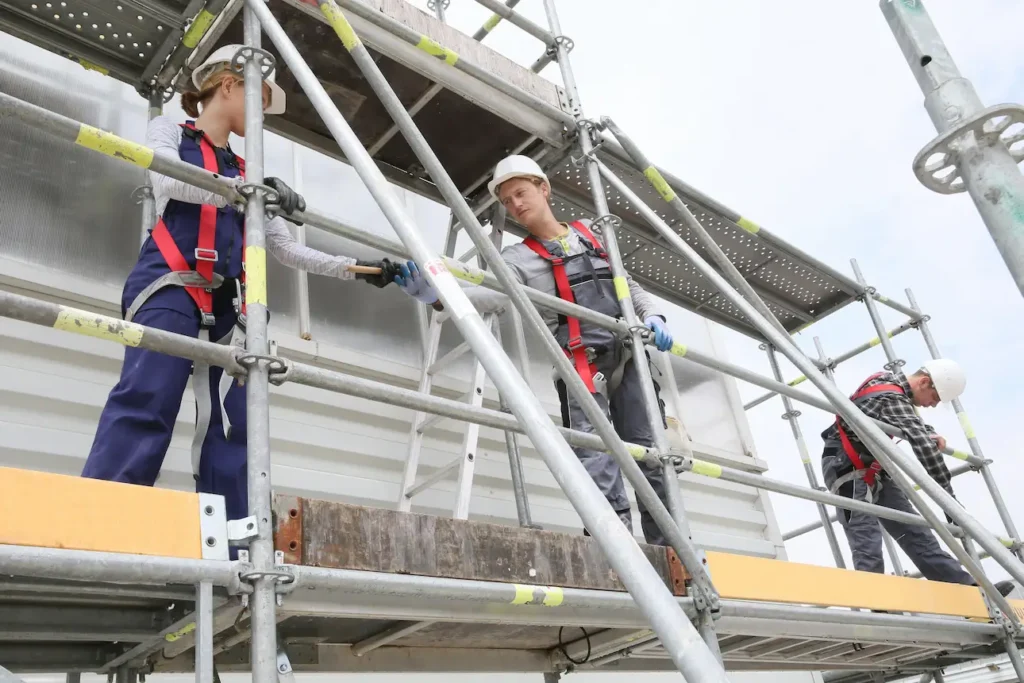 Dense scaffolding framework supporting large construction project by Downey Scaffolding Rental