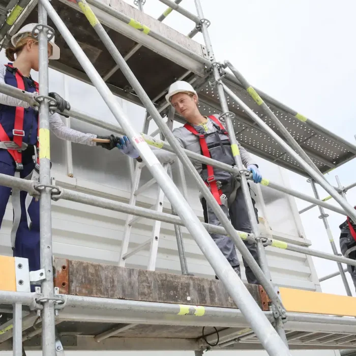 Dense scaffolding framework supporting large construction project by Downey Scaffolding Rental