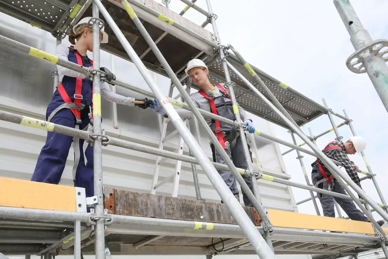 Dense scaffolding framework supporting large construction project by Downey Scaffolding Rental
